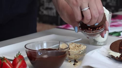 Woman Decorating Cookie with Sprinkles and Chocolate