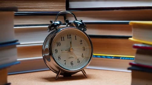 Analog Old Classic Alarm Clock Among Stack of Books