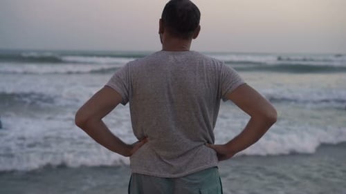 Young Man Relaxing on Beach and Admire View Admire