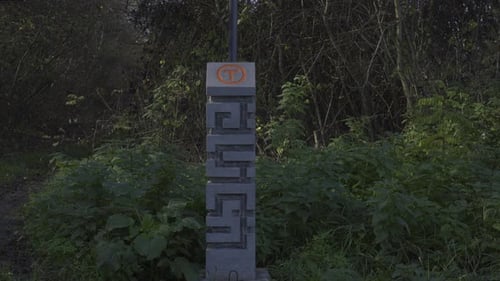 Tourist signpost for Via Transilvanica in the Terra Dacica region. The tourist marker carved in ande