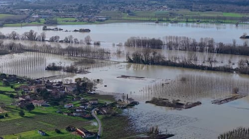 Aerial view of floodwaters engulfing fields and buildings, Gironde, France.