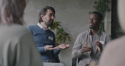 Multiracial Group of Men and Women Talking Sharing Problems Focused on Therapy Session in Center