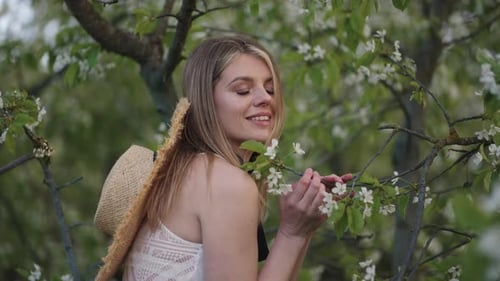 Portrait of Pretty Woman in Blooming Garden in Spring Day Smiling Female Face and Beautiful Blossoms