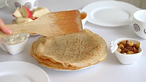 Stack of pancakes with cheese, honey, apple