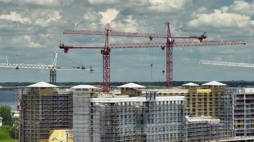 Tower Cranes and Frame Structure of High Residential Apartment Buildings at Construction Site