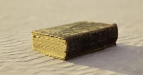 Antique Book Zoom Out on Textured Surface