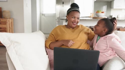 Woman and Child Enjoying Time Together Using Laptop