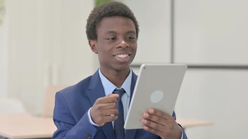 Young Man Attends Virtual Meeting With Tablet