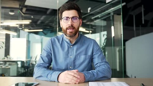 Webcam view. Confident businessman talking on a video call looking at the camera sitting