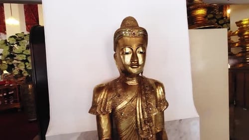 Buddhism: small Golden Buddha Statue in a temple.