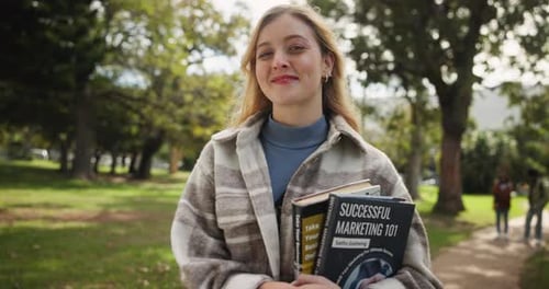 Happy woman, student and confidence with books at park for learning, education