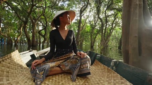 Woman Boating Through Tropical River