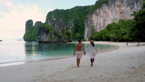 Couple Exploring the Serene Beaches of Krabi Thailand Under the Sun