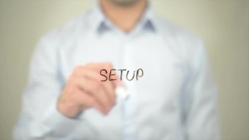 Hand Writes Word "Setup" on Transparent Surface