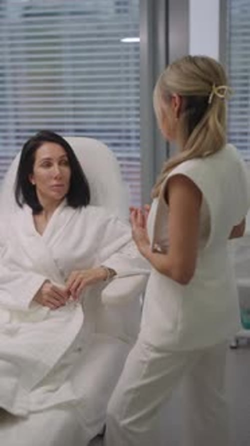 Woman in Robe Consults with Doctor in Clinic