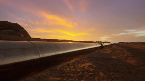 Oil and Gas Pipeline in Desert Landscape at Sunset