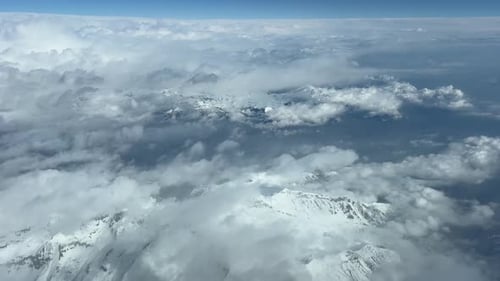 POV of The Alps Mountains with the snowed peaks, shot from an airplane cockpit in a real time flight