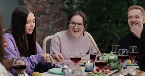 Young Adults Enjoying Food Together at City Table