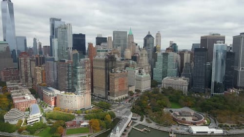 Aerial view of skyscrapers in lower Manhattan, in cloudy NYC - tracking, drone shot