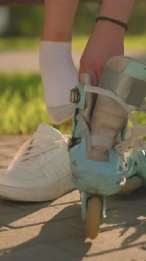 Woman Prepares to Roller Blade in Park