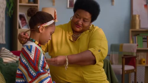 Woman Helping Child with Jewelry at Home