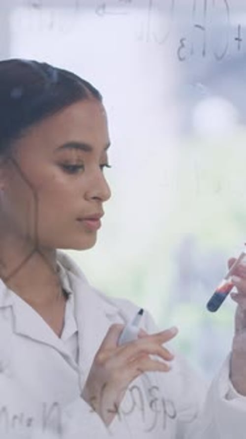 Scientist, woman and writing on glass wall in lab for blood sample, DNA analysis or enzyme reaction
