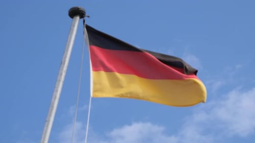 German Flag Waving Against a Blue Sky