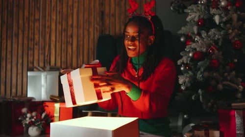 Woman Opens Christmas Gift with Glowing Light