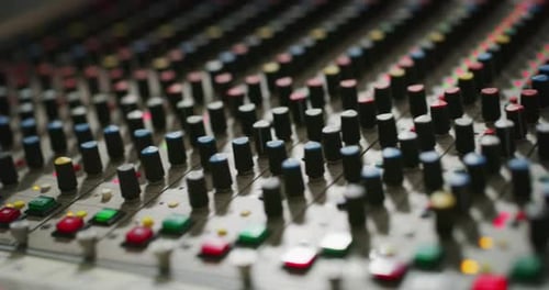 Macro slide shot of a music mixer with editing tools in a professional recording studio.