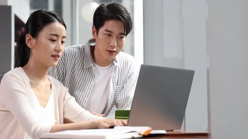 Young Adults Working Together on a Laptop Indoors