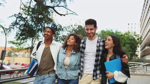 Students of different backgrounds walking and laughing together on campus