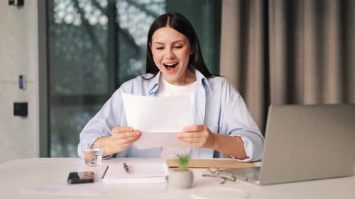 Excited young woman receives good news in letter