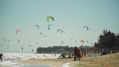 Beach full of colorful kites flying in a blue sky .Vietnam. Real Time. Daylight