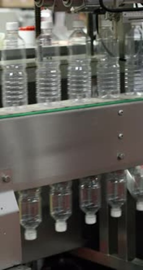 Automated Production Line Moving Clear Plastic Bottles in a Factory