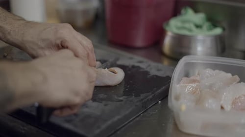 Chef Cutting Fish in the Kitchen
