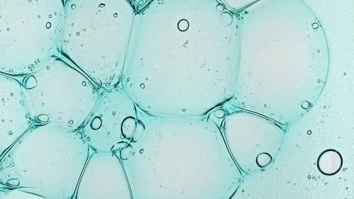 Transparent Bubble Cluster Cells Under a Microscope Cosmetic Gel Fluid with Molecule Bubbles