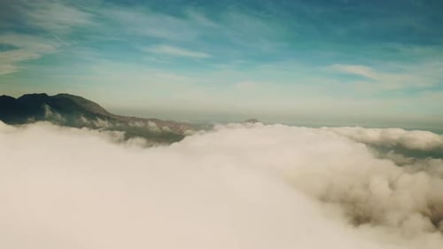 4k drone footage of clouds high above a mountainous area