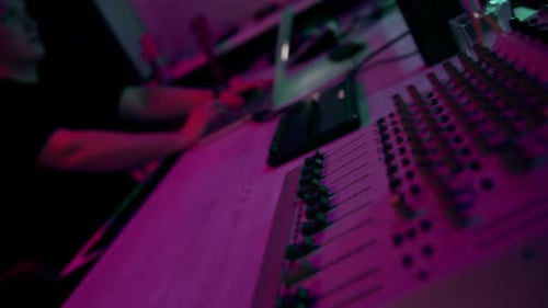 professional sound recording studio sound engineer or music producer sitting at the remote control