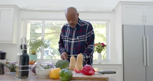 Senior Man Prepares Healthy Meal in Kitchen