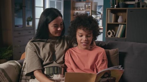 Woman and Child Read Comic Book at Home