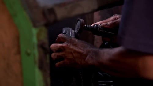 Close Up of Hands Using Grinding Machine