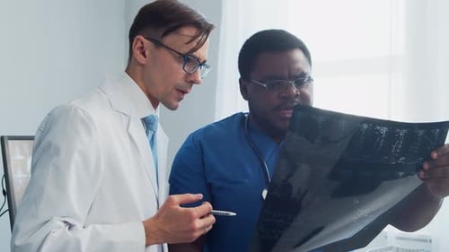 Doctor and Surgeon Talking Near Window Medical Workers in Hospital Office Day Light Healthcare