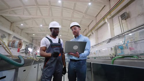 Two Workers Walking and Check the Cooling System of the Production Line