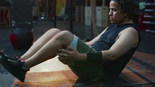 Athletic Man Doing Abdominal Exercises at Gym