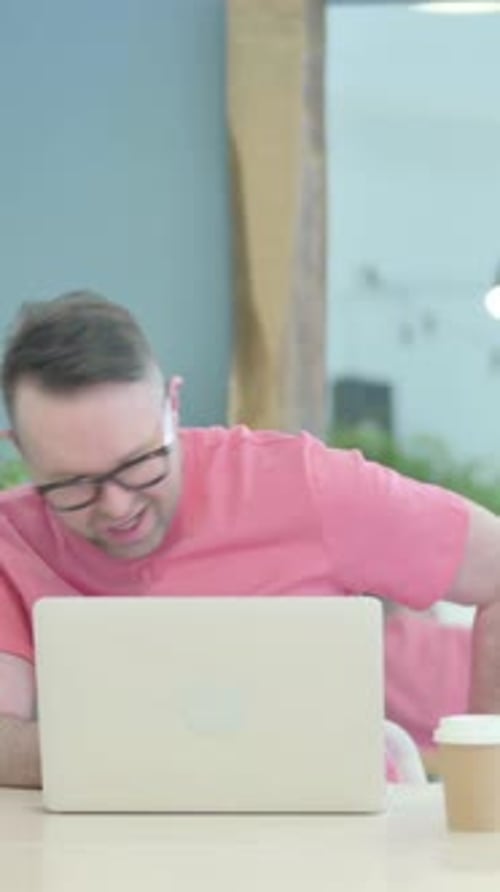 Man Working at Laptop Experiencing Back Pain