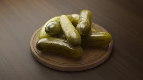 Rotating Dill Pickles on Wooden Board Appetizer Loop
