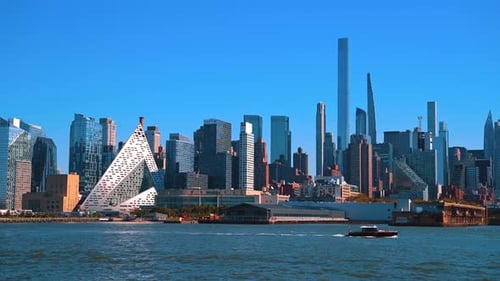 Boat travels by the East River along the spectacular skyline of New York, USA.