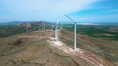 A large sinkhole, lake and wind turbines