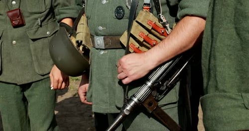 People in Military Uniforms Holding Guns