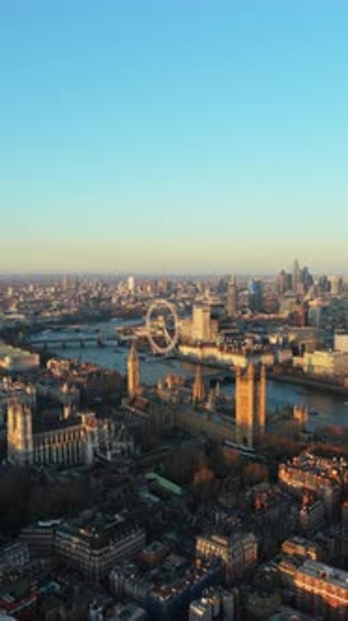 Golden Hour Light Illuminating Iconic Palace of Westminster Big Ben and London Eye Observation Wheel